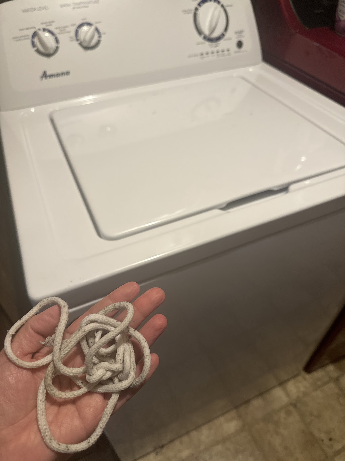 Blaine holding a drawstring removed from an Amana washing machine